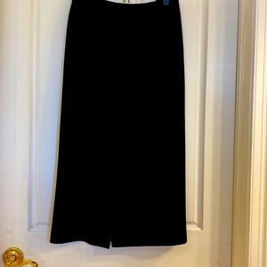 Black 100% wool skirt,  midi length with front slit. Excellent condition.